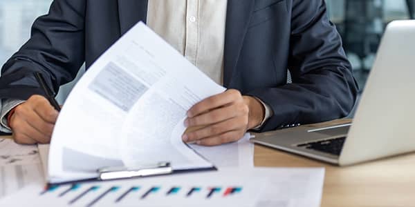 Reviewing papers with laptop